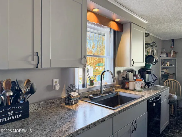 a kitchen with a sink and cabinets