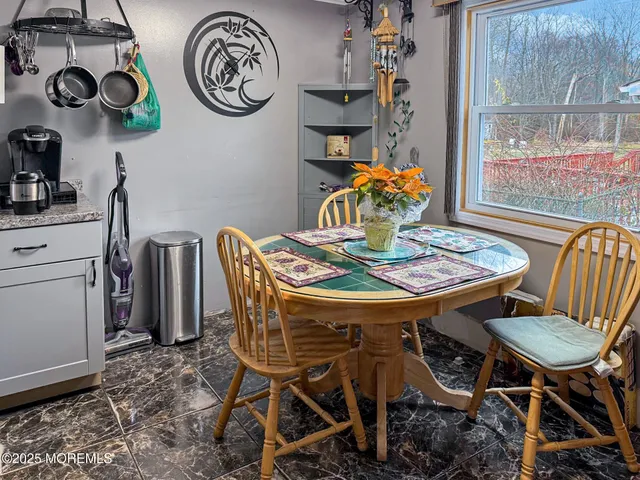 a dining room with furniture and window