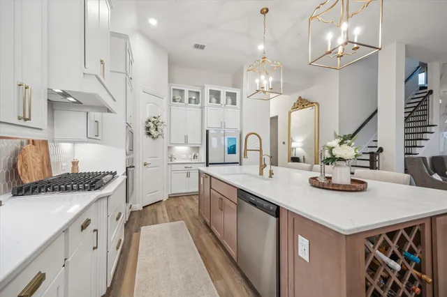 a kitchen with stainless steel appliances a sink and stove