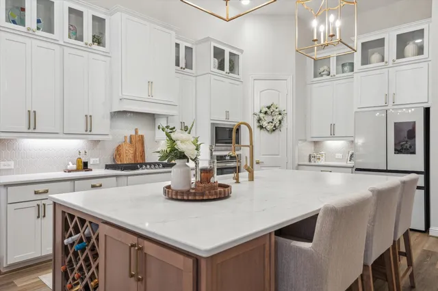 a kitchen with cabinets a sink and appliances
