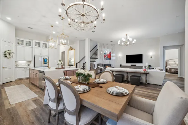 a view of a dining room with furniture a chandelier and wooden floor