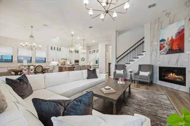 a living room with furniture kitchen view and a fireplace