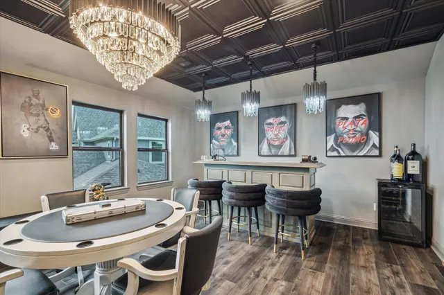 a view of a dining room with furniture a chandelier and wooden floor