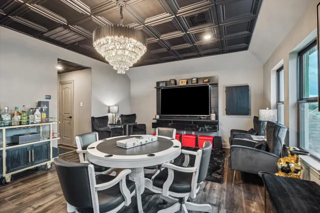 a view of a dining room with furniture a chandelier and wooden floor