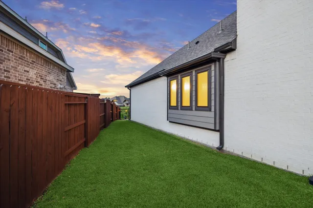 an aerial view of a house with outdoor space and lake view