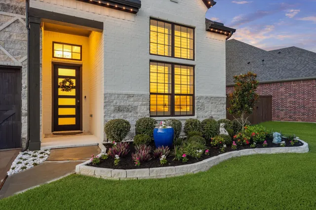 a view of a house with a garden and plants