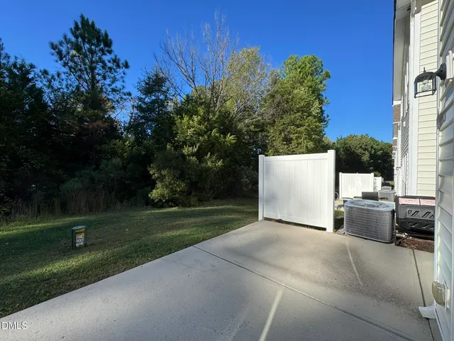 a view of backyard with outdoor seating and green space