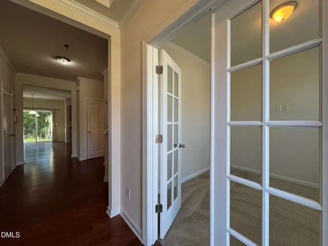 a view of a hallway with wooden floor