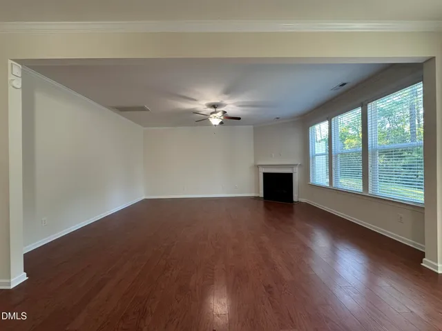 a view of a livingroom with a ceiling fan and hardwood floor