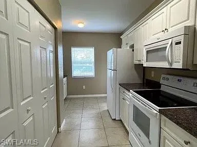 a view of an empty room and a bathroom