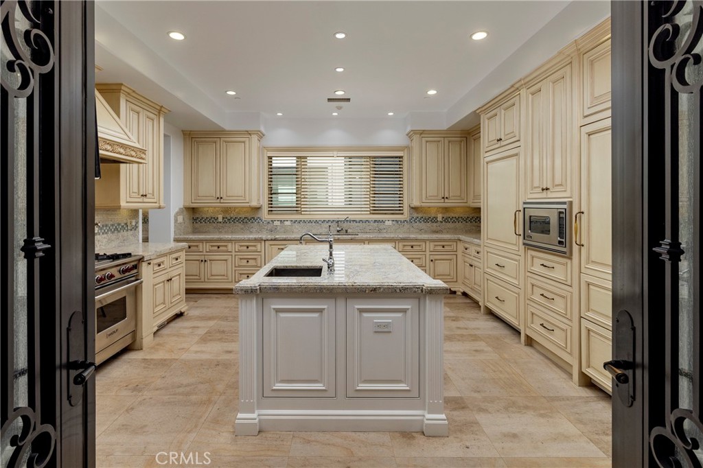 2258 Channel Road Newport Beach, CA 92661 - Photo 16 of 54 a kitchen with a sink stove and cabinets