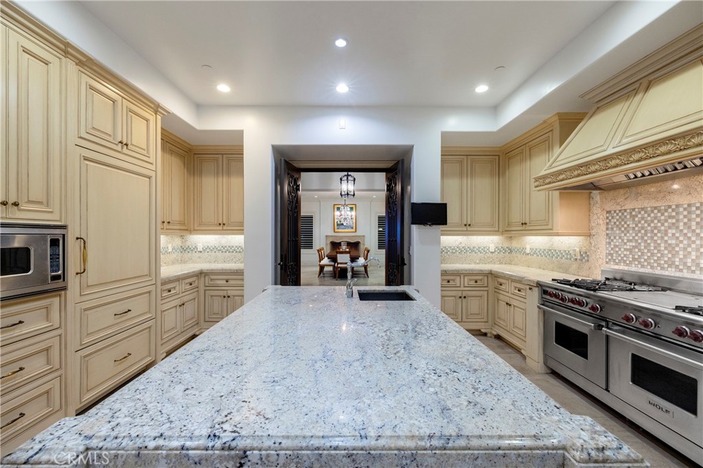 2258 Channel Road Newport Beach, CA 92661 - Photo 17 of 54 a large kitchen with stainless steel appliances granite countertop a stove and a sink