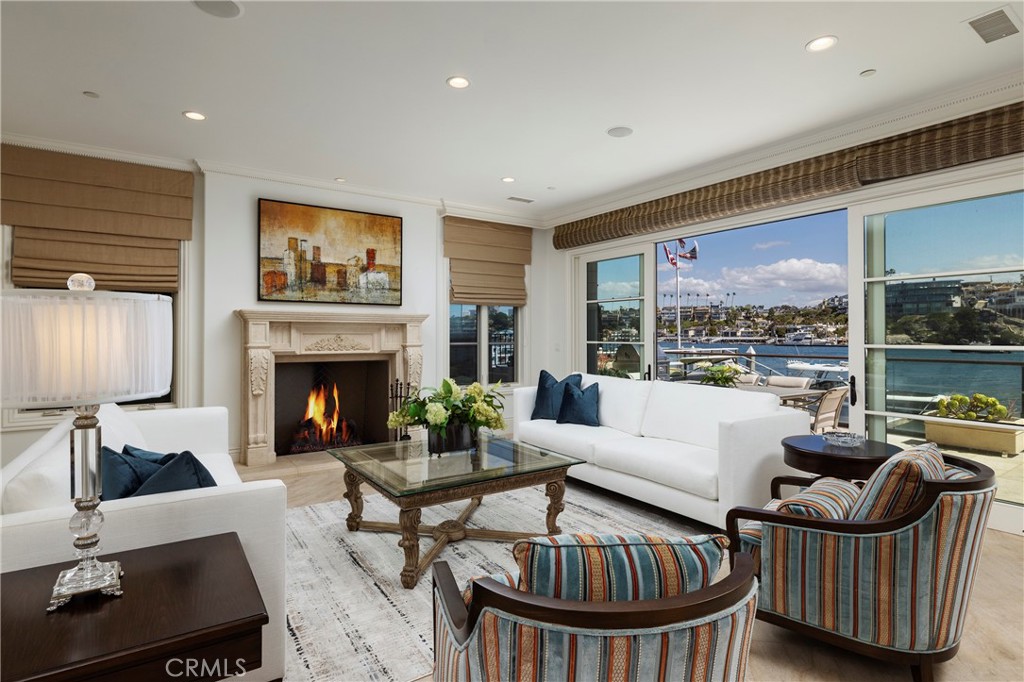 2258 Channel Road Newport Beach, CA 92661 - Photo 4 of 54 a living room with furniture a fireplace and a large window