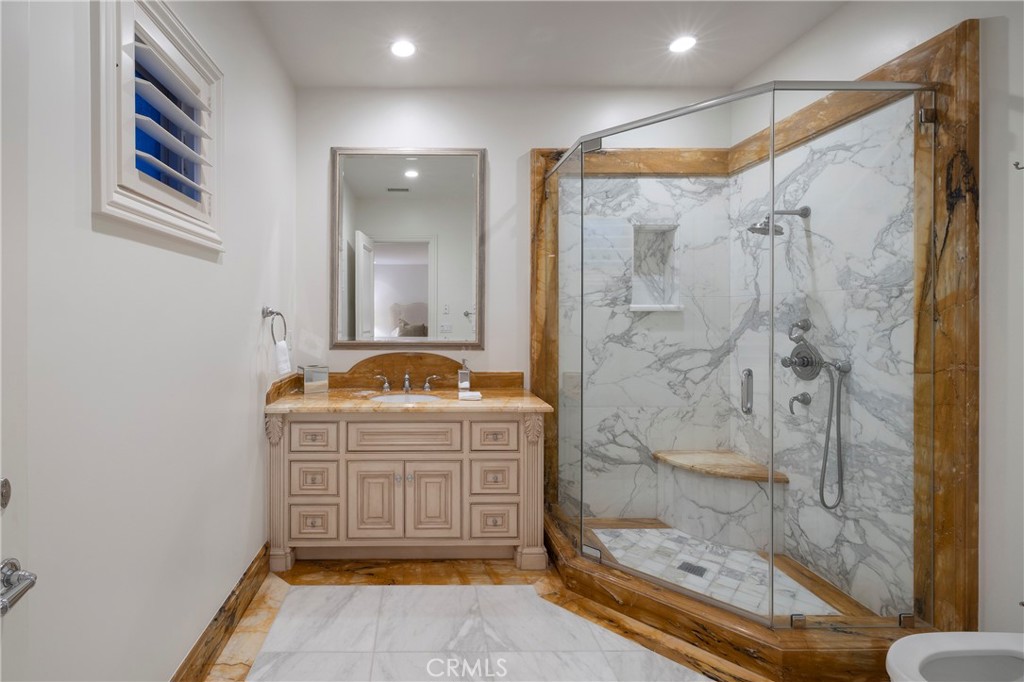 2258 Channel Road Newport Beach, CA 92661 - Photo 42 of 54 a bathroom with a granite countertop sink a mirror a bathtub and shower