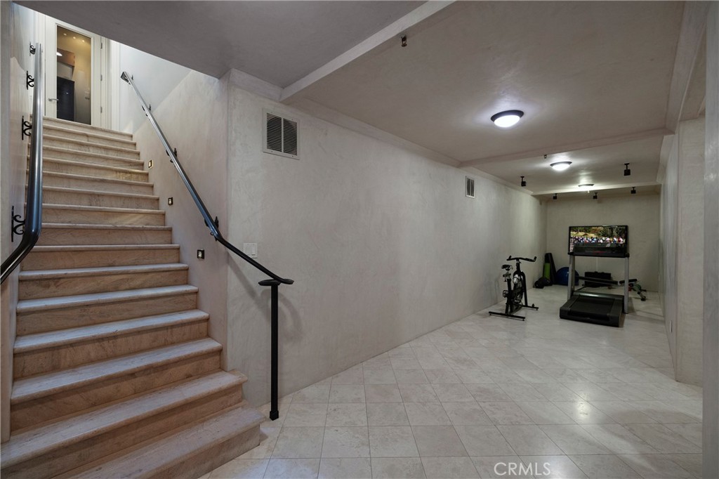 2258 Channel Road Newport Beach, CA 92661 - Photo 43 of 54 a view of a livingroom with stairs and a ceiling fan