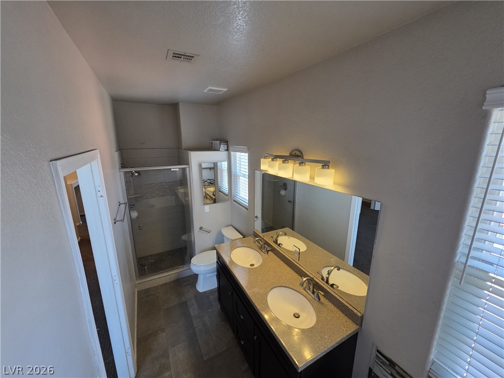 2275 Ramsgate Drive Henderson, NV 89074 - Photo 62 of 84 Double vanity and a spacious walk-in shower elevate this well-appointed bathroom.