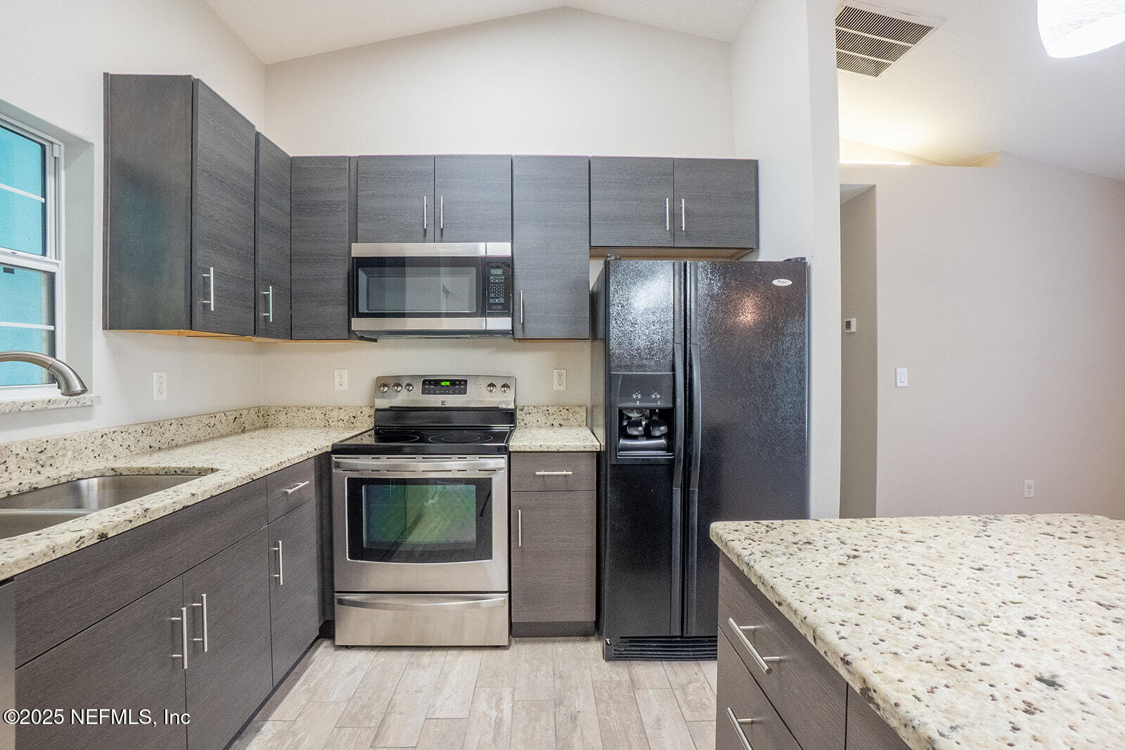 29 Edith Pope Drive Palm Coast, FL 32164 - Photo 11 of 26 a kitchen with a sink stove and refrigerator