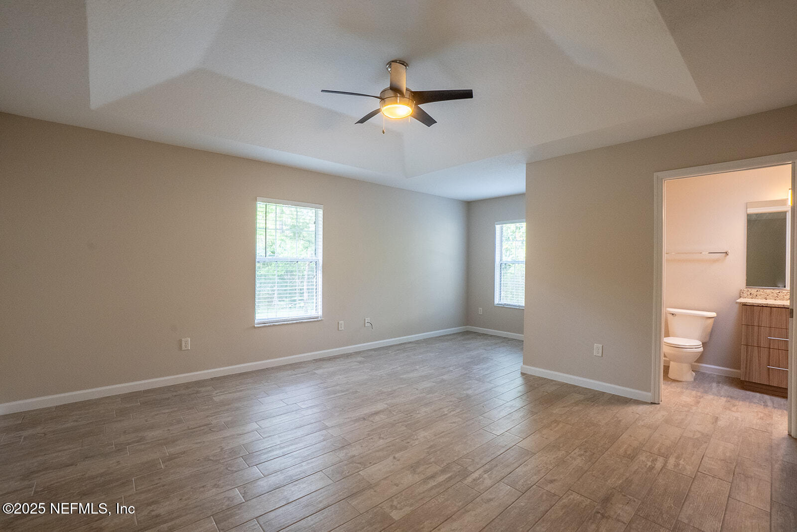 29 Edith Pope Drive Palm Coast, FL 32164 - Photo 12 of 26 a view of an empty room with wooden floor and a window