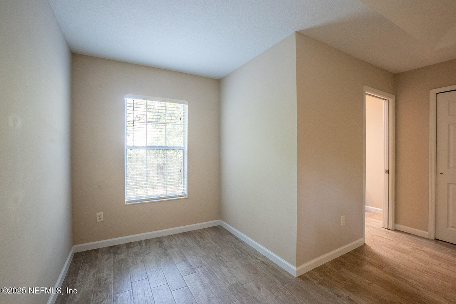 29 Edith Pope Drive Palm Coast, FL 32164 - Photo 13 of 26 an empty room with wooden floor and windows