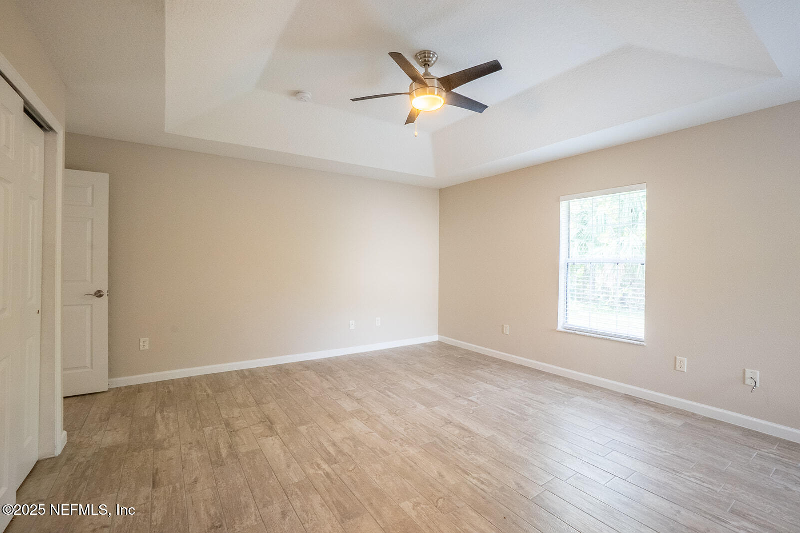 29 Edith Pope Drive Palm Coast, FL 32164 - Photo 14 of 26 a view of an empty room with wooden floor and a window