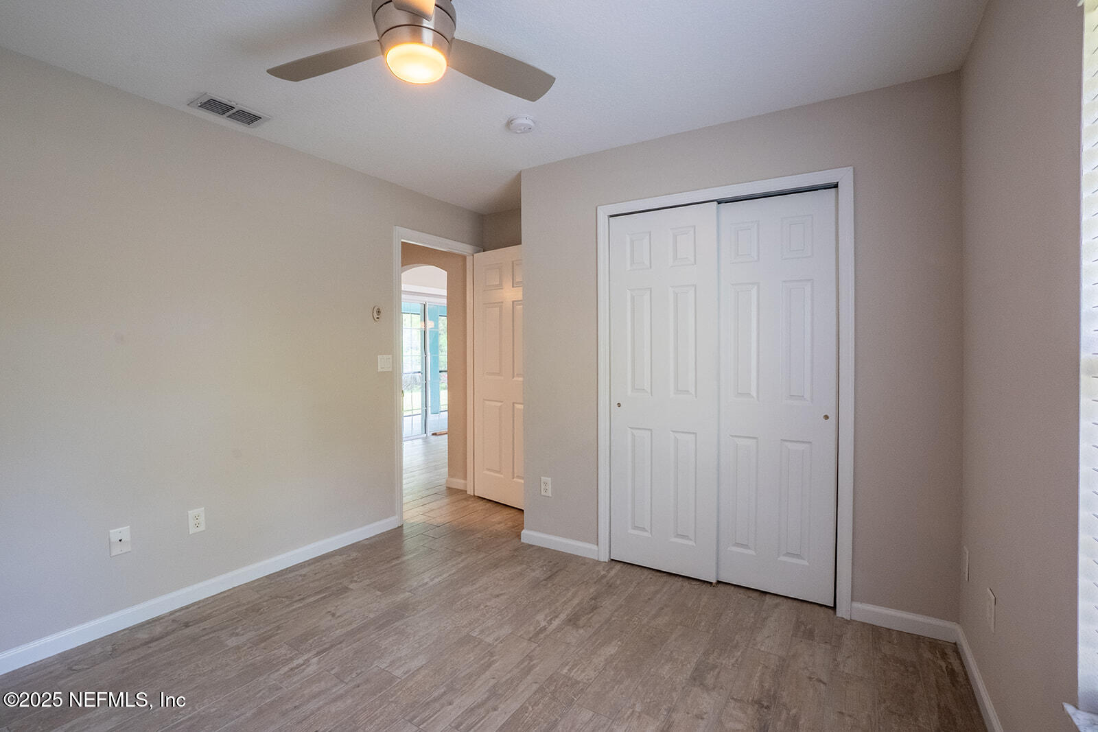 29 Edith Pope Drive Palm Coast, FL 32164 - Photo 18 of 26 wooden floor in an empty room with a window