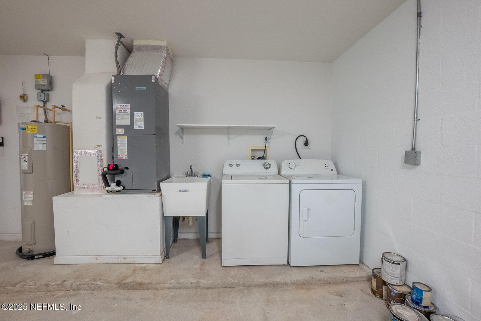 29 Edith Pope Drive Palm Coast, FL 32164 - Photo 21 of 26 a utility room with cabinets washer and dryer