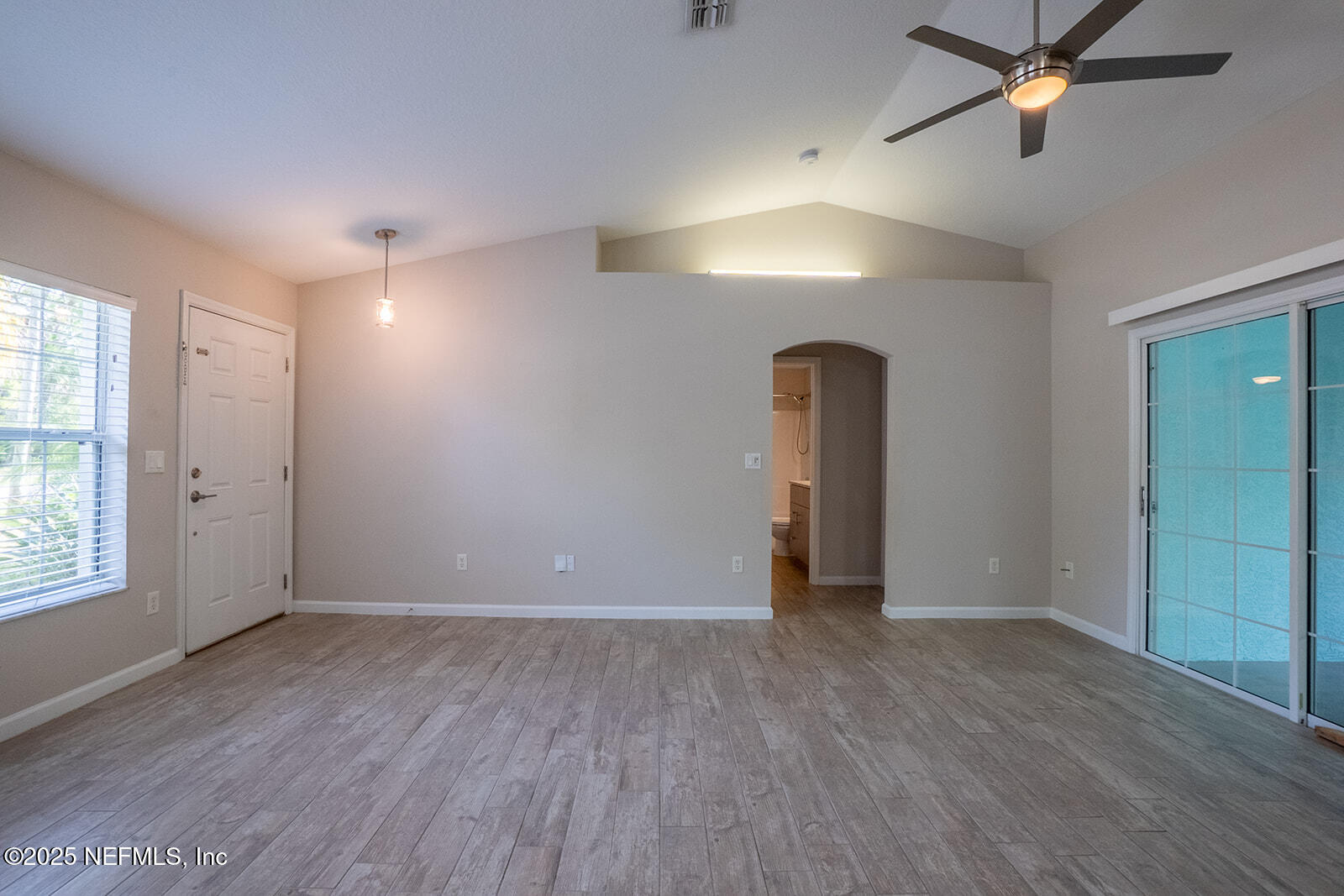 29 Edith Pope Drive Palm Coast, FL 32164 - Photo 8 of 26 wooden floor in an empty room with a window
