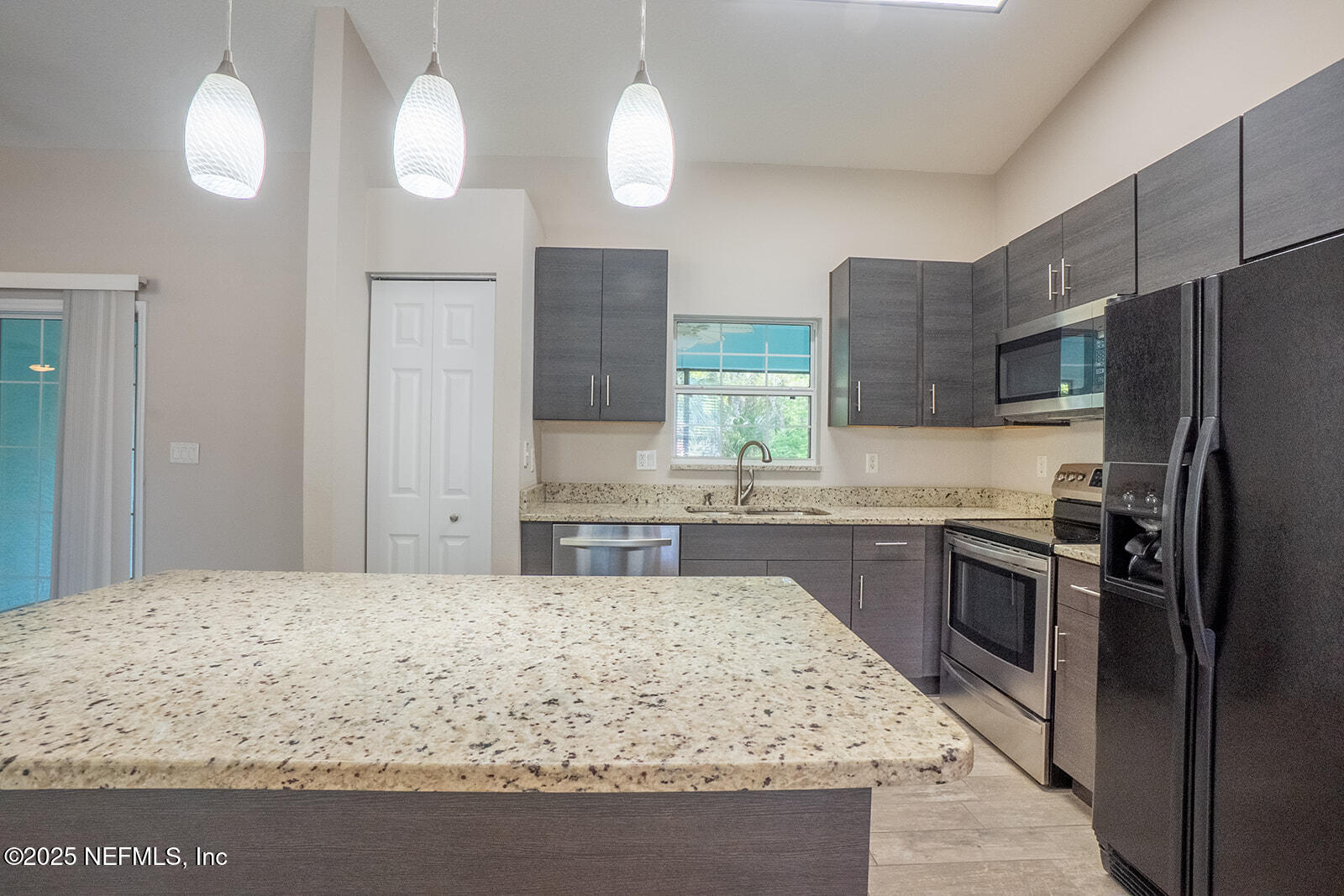 29 Edith Pope Drive Palm Coast, FL 32164 - Photo 10 of 26 a kitchen with stainless steel appliances granite countertop a sink stove and refrigerator