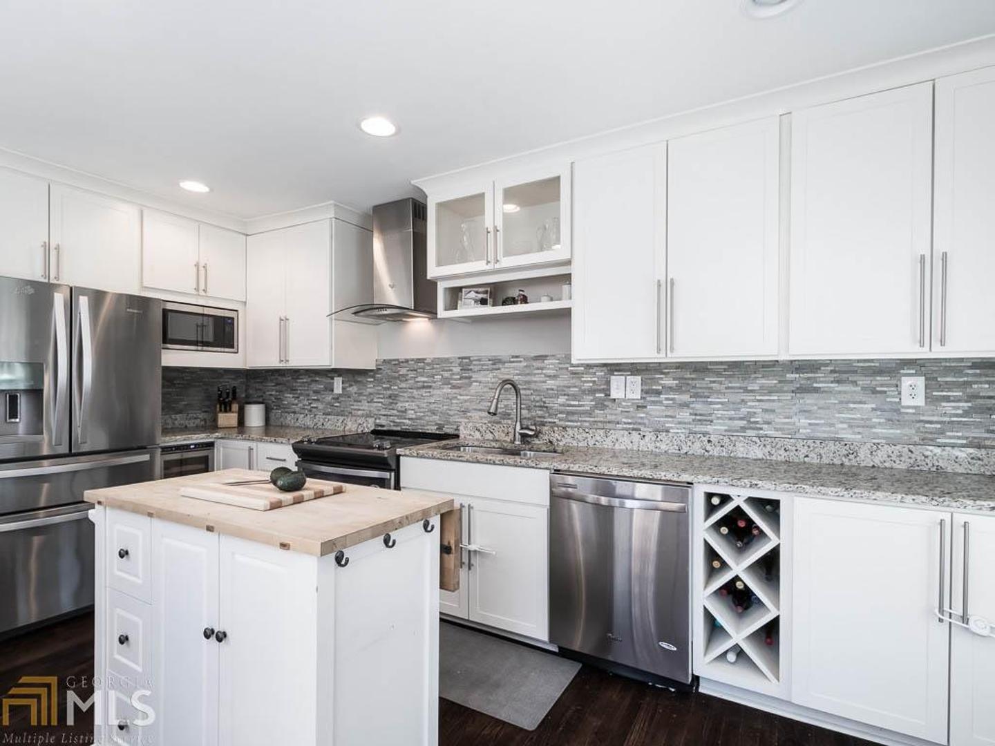 2419 Lavista Road Atlanta, GA 30329 - Photo 1 of 1 a kitchen with white cabinets stainless steel appliances and sink