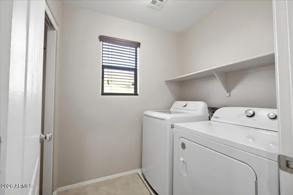 a view of storage and utility room with washer and dryer
