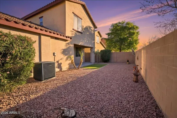 a backyard of a house with barbeque oven and outdoor seating