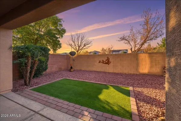 a view of a yard with a house in the background