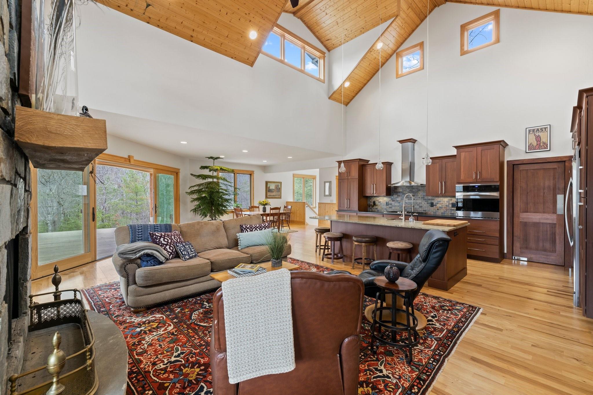 41 Rowan Hl Road Leicester, NC 28748 - Photo 13 of 48 a living room with furniture a fireplace and a flat screen tv