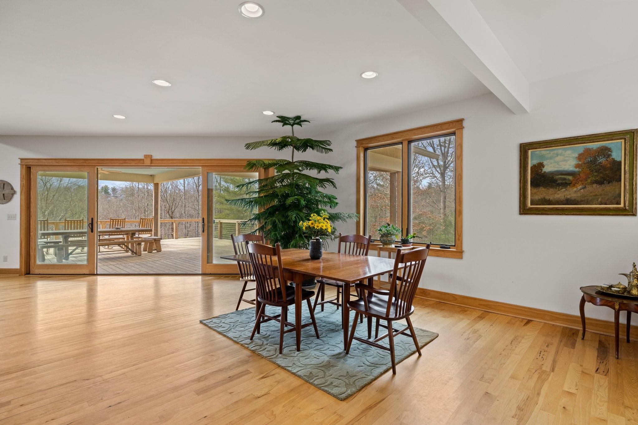 41 Rowan Hl Road Leicester, NC 28748 - Photo 15 of 48 a dining room with furniture wooden floor and a potted plant