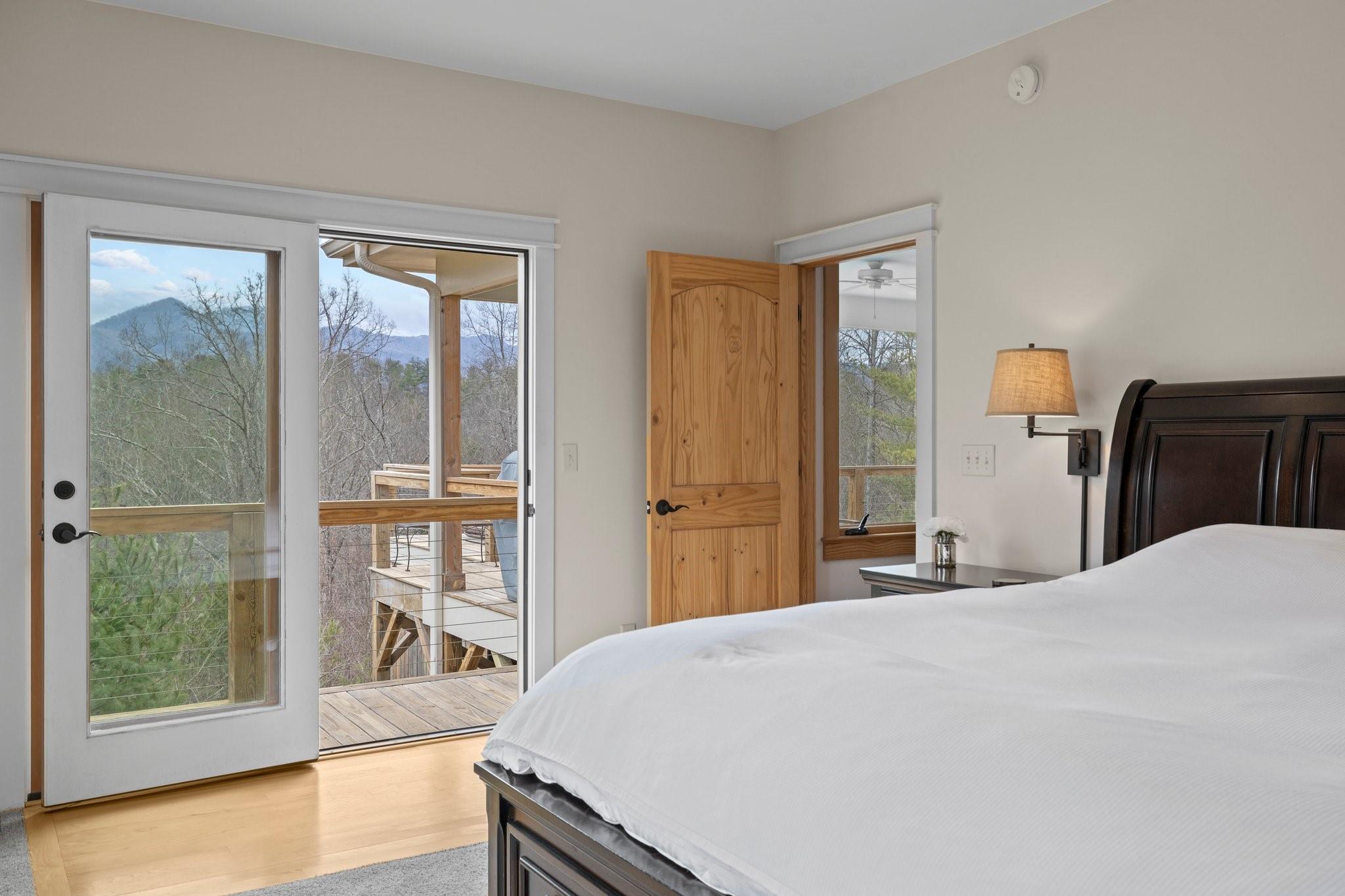 41 Rowan Hl Road Leicester, NC 28748 - Photo 23 of 48 a bedroom with a large bed and a large window