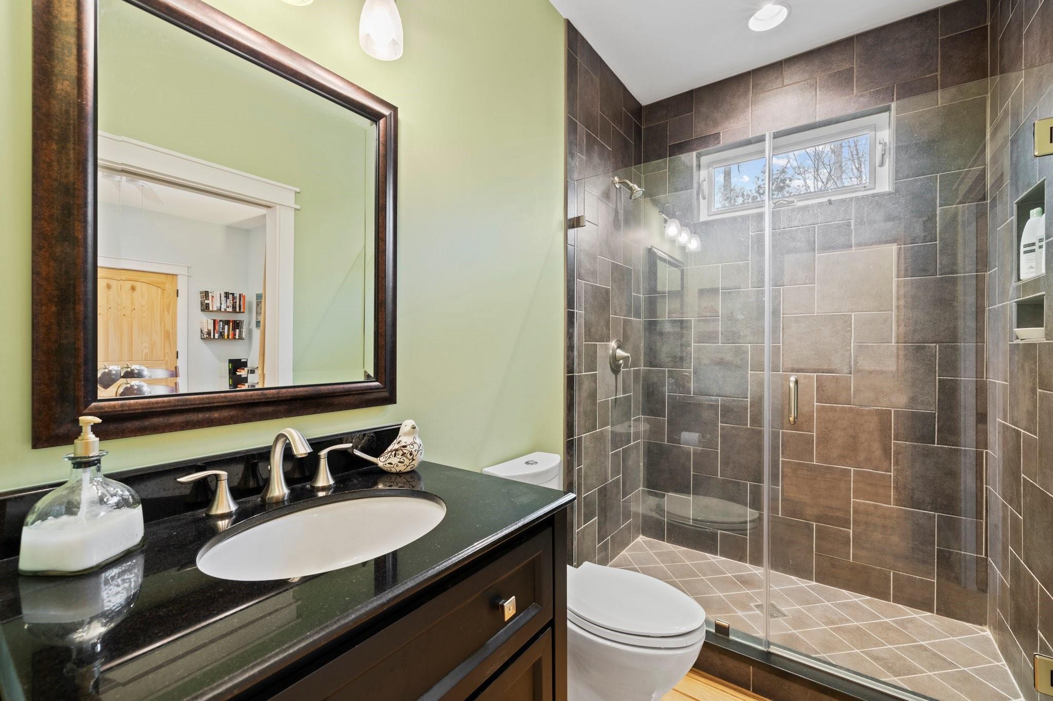 41 Rowan Hl Road Leicester, NC 28748 - Photo 29 of 48 a bathroom with a double vanity sink toilet mirror and shower