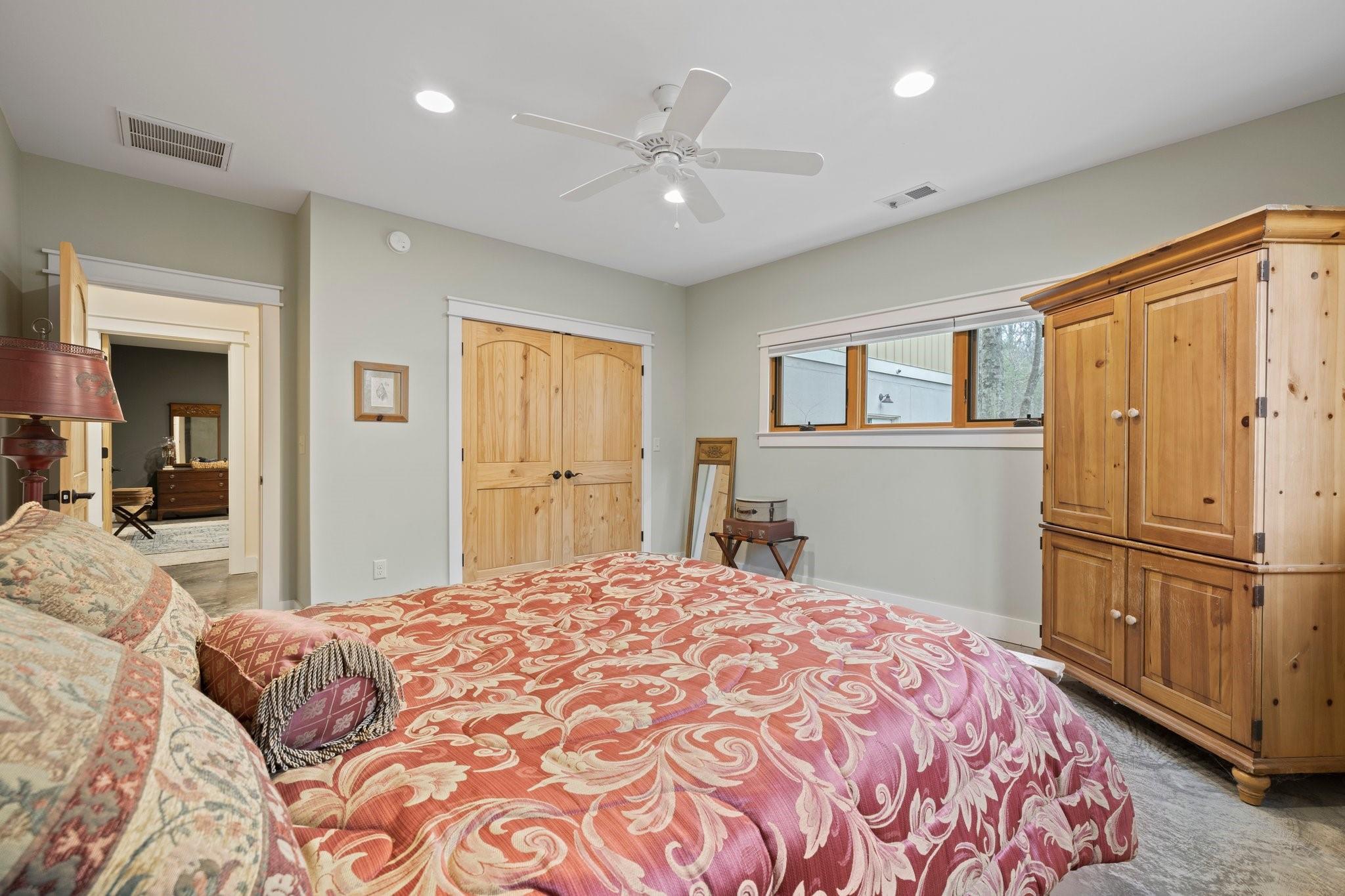 41 Rowan Hl Road Leicester, NC 28748 - Photo 40 of 48 a bedroom with a large bed a flat tv screen and dresser