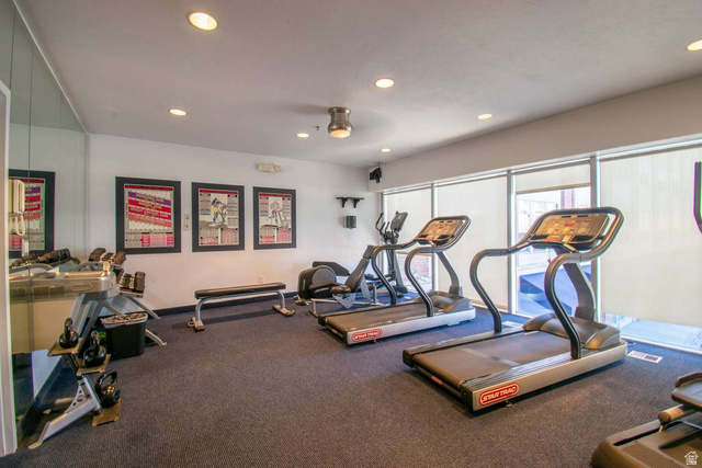 4276 South Main Street, Unit 303 Murray, UT 84107 - Photo 19 of 20 Fitness room featuring carpet flooring, recessed lighting, and wall-to-wall mirrors