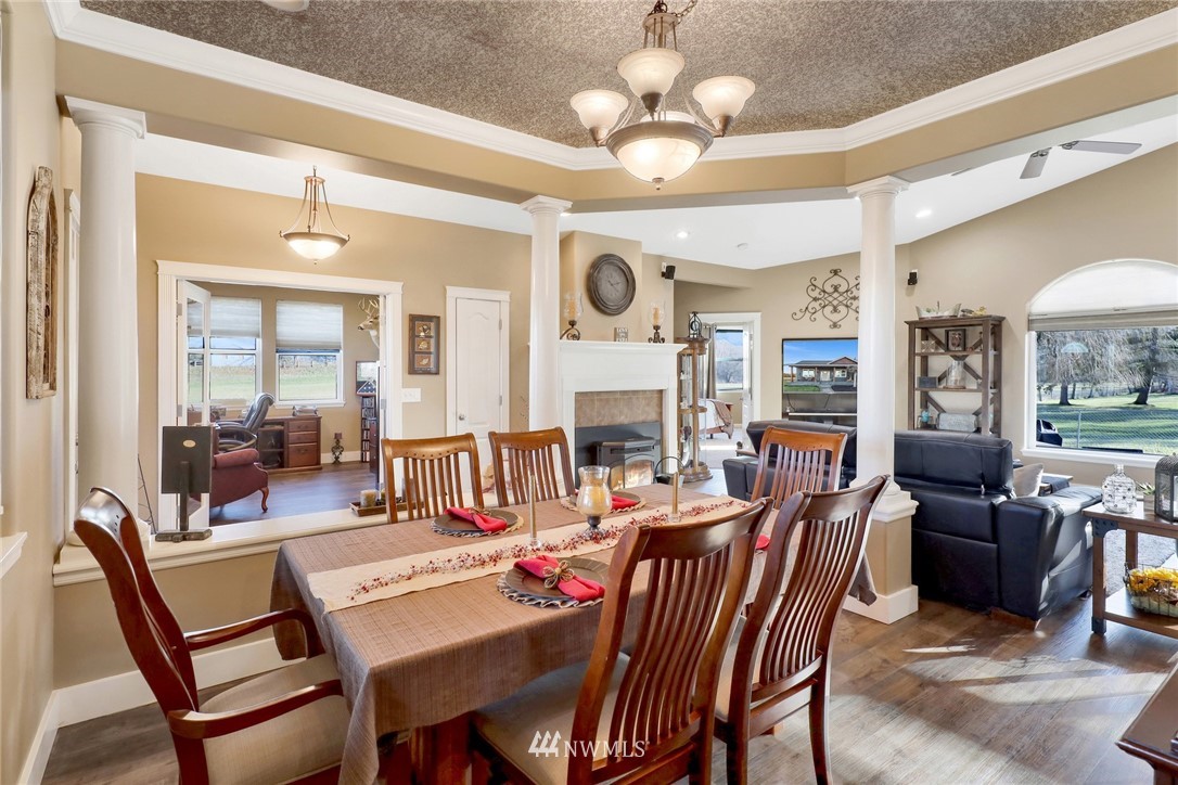 1107 Slater Road Bellingham, WA 98226 - Photo 17 of 39 a view of a dining room with furniture a chandelier and large windows