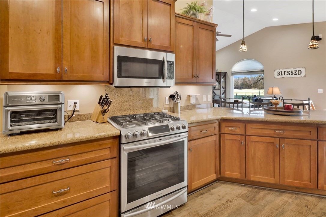 1107 Slater Road Bellingham, WA 98226 - Photo 20 of 39 a kitchen with stainless steel appliances granite countertop a stove microwave and cabinets