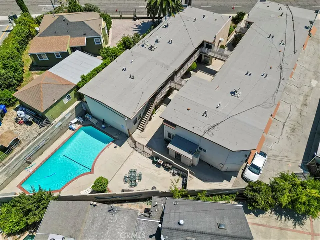 an aerial view of a house with a mountain