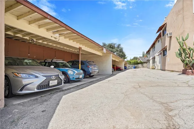 a view of a street with a car parked in front of it