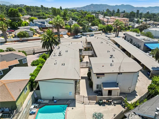 an aerial view of a house with a yard and potted plants