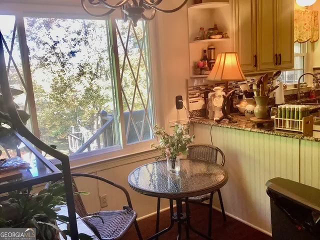 a view of a dining room with furniture and window