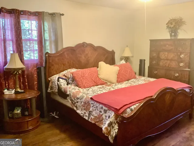 a bedroom with a bed and window