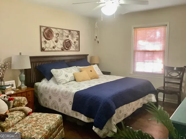 a bedroom with a bed and a window