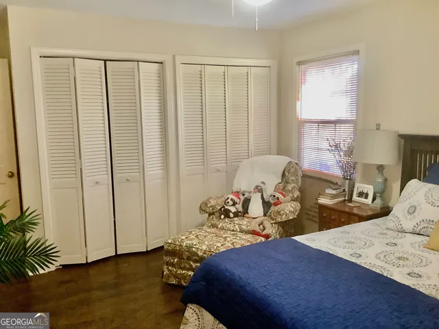 a bedroom with bed and glass door
