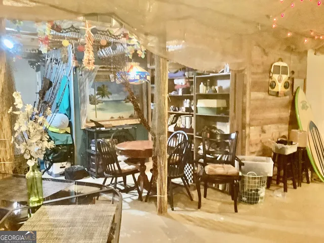 a bedroom with a bed a mirror and musical instruments