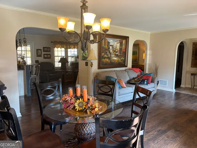 a view of a dining room with furniture and wooden floor