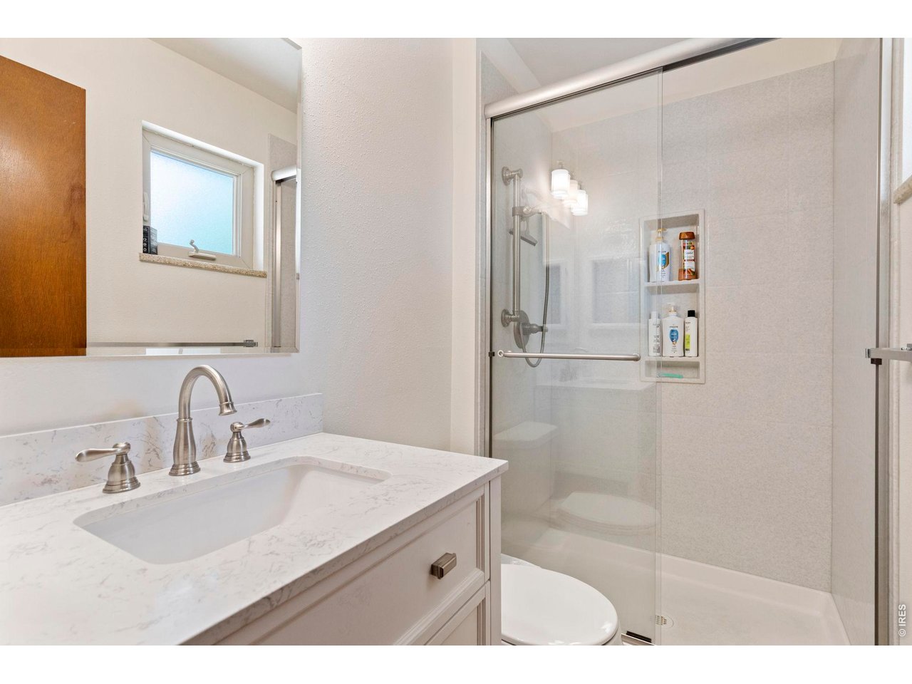 300 Ranch Acres Drive Loveland, CO 80538 - Photo 18 of 38 a bathroom with a sink a shower and a mirror
